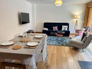 a living room with a table and a couch at Appartement Les Gets, 3 pièces, 6 personnes - FR-1-623-116 in Les Gets