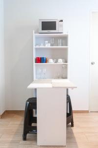 a white desk with a microwave on top of it at Confortable and functional SUITE in MIRAFLORES ! in Lima