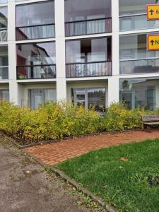 an apartment building with a bench in front of it at Cozy apartment with a yard in Kivistö near Airport in Vantaa