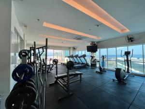 a gym with treadmills and weights in a building at Quarto de Luxo - Saint Moritz in Brasilia