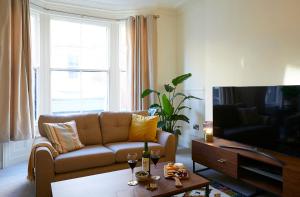 a living room with a couch and a tv at The Stoop in Scarborough