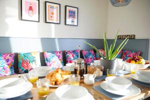 a dining room table with white dishes on it at The Stoop in Scarborough