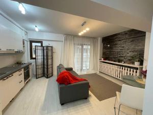 un soggiorno con divano e cucina di Apartament 2 camere Mogoșoaia a Mogoşoaia