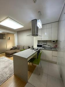 a kitchen with a large island in a room at Апартаменты в Хайвилл in Astana