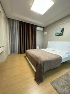 a bedroom with a large bed in a room at Апартаменты в Хайвилл in Astana