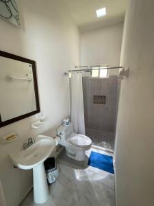 a bathroom with a toilet and a sink and a shower at Casa esperanza in Progreso +2 photos