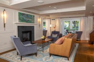 a living room with a couch and a fireplace at Boar's Head Resort in Charlottesville