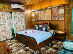 a bedroom with a bed with a tray on it at House Boat New Lucifer in Srinagar