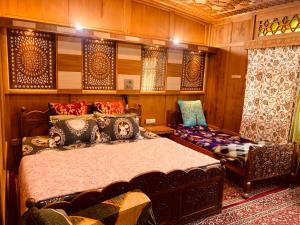 a bedroom with a bed and a chair in a room at House Boat New Lucifer in Srinagar