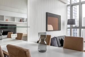 a dining room with a table with a glass vase on it at Luxury 1Bedroom Apartment in Singapore! in Singapore
