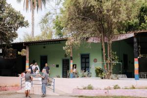 a group of people standing in front of a green building at Regenera Gaia in Betim