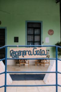 a blue railing with a sign that reads reedera goria at Regenera Gaia in Betim