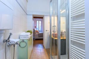 a bathroom with a glass shower and a sink at Parma Parco Ducale Cozy Apartment in Parma