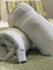 a white towel with a candle on top of it at Black Bull Hotel in Bellingham