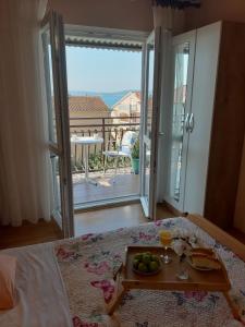 a bedroom with a tray of fruit on a table at Guesthouse Brodarica (3814) in &Scaron;ibenik