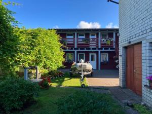 a house with a boat parked in the yard at Zelta Ābols in Ventspils