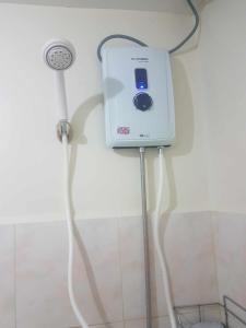 a device is plugged into a wall with a cord at Davao City Condo Living Made Easy Lifestyle in Davao City