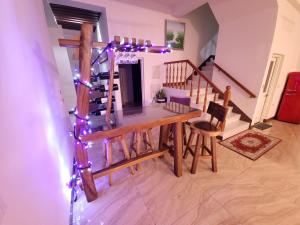 a room with a table and a staircase with christmas lights at Zhen Mei Lu Villa in Puli