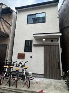 a group of bikes parked in front of a building at 桜の宿 高田 provide two free bicycle in Kyoto