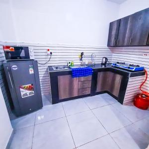 Η κουζίνα ή μικρή κουζίνα στο Studio Airbnb at Kisimani Heights