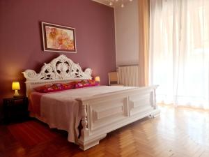 a bedroom with a large white bed with red pillows at V.home in Abano Terme