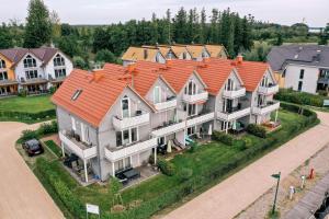 an aerial view of a large house with an orange roof at Hafendorf Haus 7 Apartment 5 Nr 89 Parkplatz am Haus in Plau am See