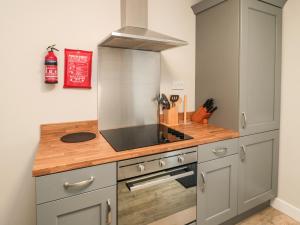 a kitchen with a sink and a stove at Goldfinch in Grindon