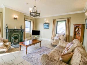 a living room with a couch and a fireplace at Ocean View in Adrigole