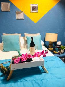 a tray with a bottle of wine and flowers on a bed at Departamento centrico - Pikachos House - in Guanajuato