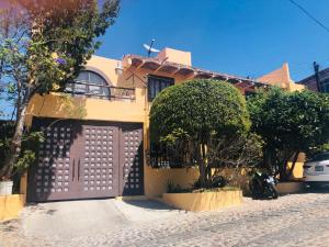 a house with a gate and a motorcycle parked in front of it at Departamento centrico - Pikachos House - in Guanajuato