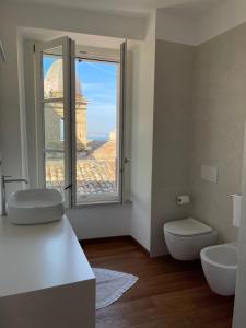 a bathroom with a toilet and a sink and a window at B&B Aganita in Ancona +55 photos