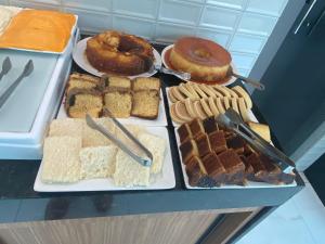 a refrigerator filled with lots of different types of desserts at Pousada Sky Beach Flat in Porto De Galinhas