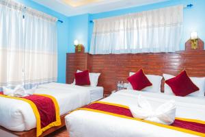 Hotel The Billabong Garden Pokhara 객실 침대