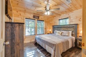 a bedroom with a bed and a ceiling fan at Paws in the Air in Pigeon Forge