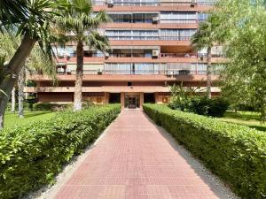 a building with a red brick walkway in front of it at Principado Wifi, Airco, Beach and Garden in Benidorm