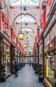 a hallway in a shopping mall with people walking through it at Newly Furnished Penthouse Mayfair in London