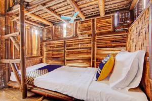 a bed in a room with wooden walls at SPOT ON 93006 Waithozz Bunkbeds in Yogyakarta