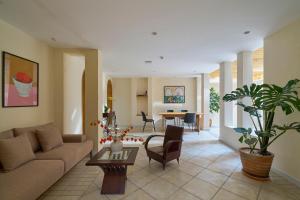 a living room with a couch and a table at M Village Living Cách Mạng Tháng 8 in Ho Chi Minh City