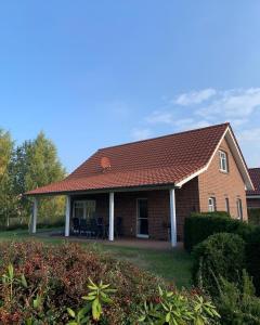 a brick house with a red roof at Haus Seeblick Nr 48 in Geeste