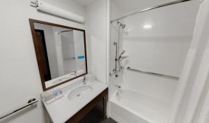a white bathroom with a sink and a mirror at Hampton Inn Majestic Chicago Theatre District in Chicago +28 photos