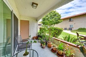 a patio with plants and a chair on a balcony at San Diego Condo Pool Access, 8 Mi to Downtown in San Diego