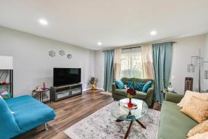 a living room with two couches and a tv at San Diego Condo Pool Access, 8 Mi to Downtown in San Diego