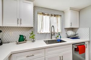 a kitchen with white cabinets and a sink at San Diego Condo Pool Access, 8 Mi to Downtown in San Diego