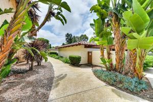 a house with palm trees and a driveway at San Diego Condo Pool Access, 8 Mi to Downtown in San Diego