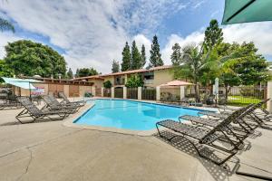 a swimming pool with lounge chairs around it at San Diego Condo Pool Access, 8 Mi to Downtown in San Diego