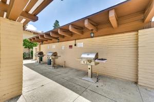 a row of bbq grills on a wooden wall at San Diego Condo Pool Access, 8 Mi to Downtown in San Diego