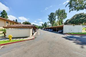 an empty street with a building and a yellow fire hydrant at San Diego Condo Pool Access, 8 Mi to Downtown in San Diego