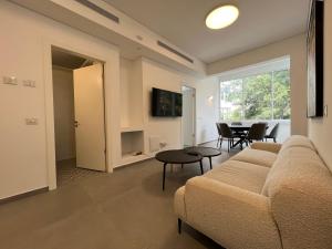 a living room with a couch and a table at Smolenskin 3 Bedrooms Apartment in Tel Aviv