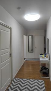 an empty room with a white door and a mirror at Central Park Home in Turku