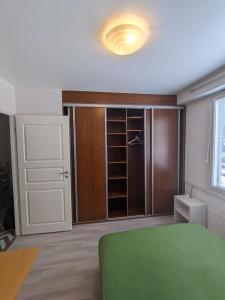 a bedroom with a green bed and a closet at Central Park Home in Turku +3 photos
